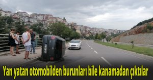 Yan yatan otomobilden burunları bile kanamadan çıktılar