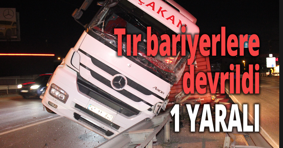 Tır bariyerlere devrildi