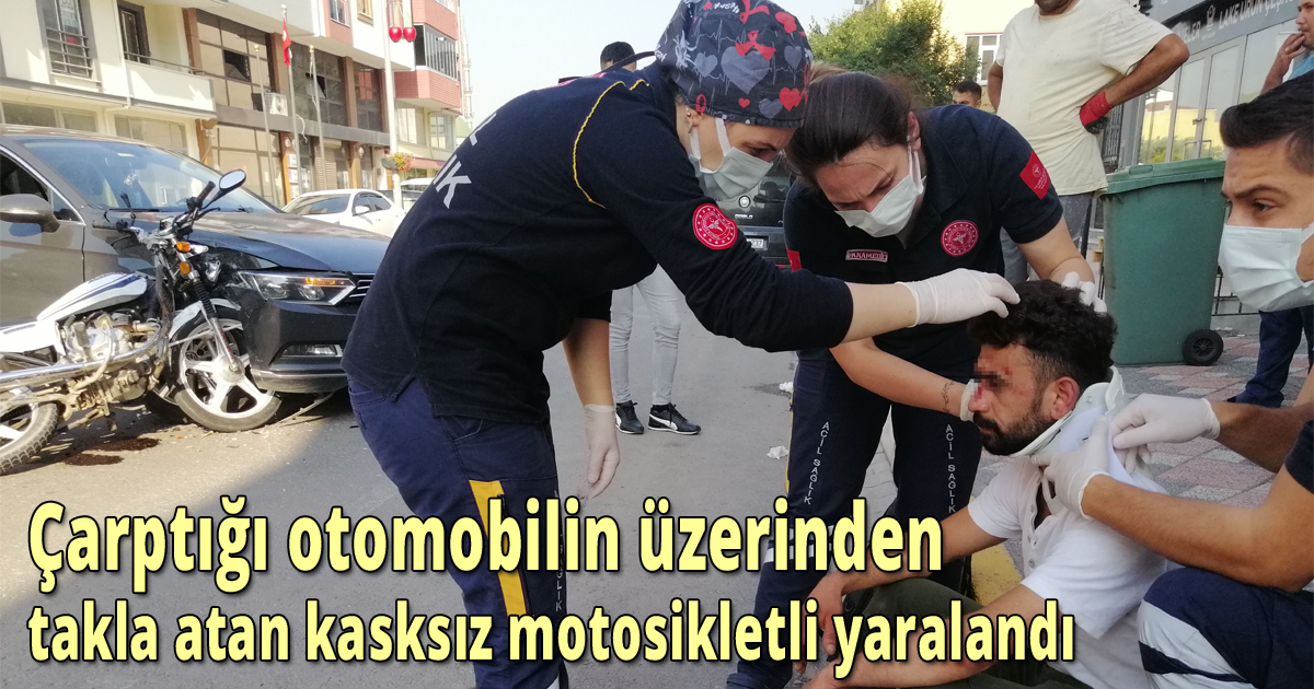 Çarptığı otomobilin üzerinden takla atan kasksız motosikletli yaralandı