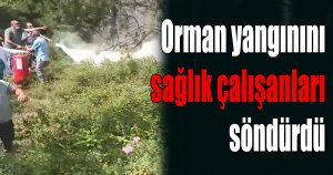 Sağlık çalışanları yangın tüpleri ile yanan ormanı söndürmeye koştu