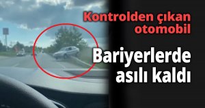  Kontrolden çıkan otomobil bariyerlerde asılı kaldı