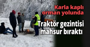  Karla kaplı orman yolunda traktör gezintisi mahsur bıraktı
