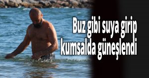 Buz gibi suya girip kumsalda güneşlendi